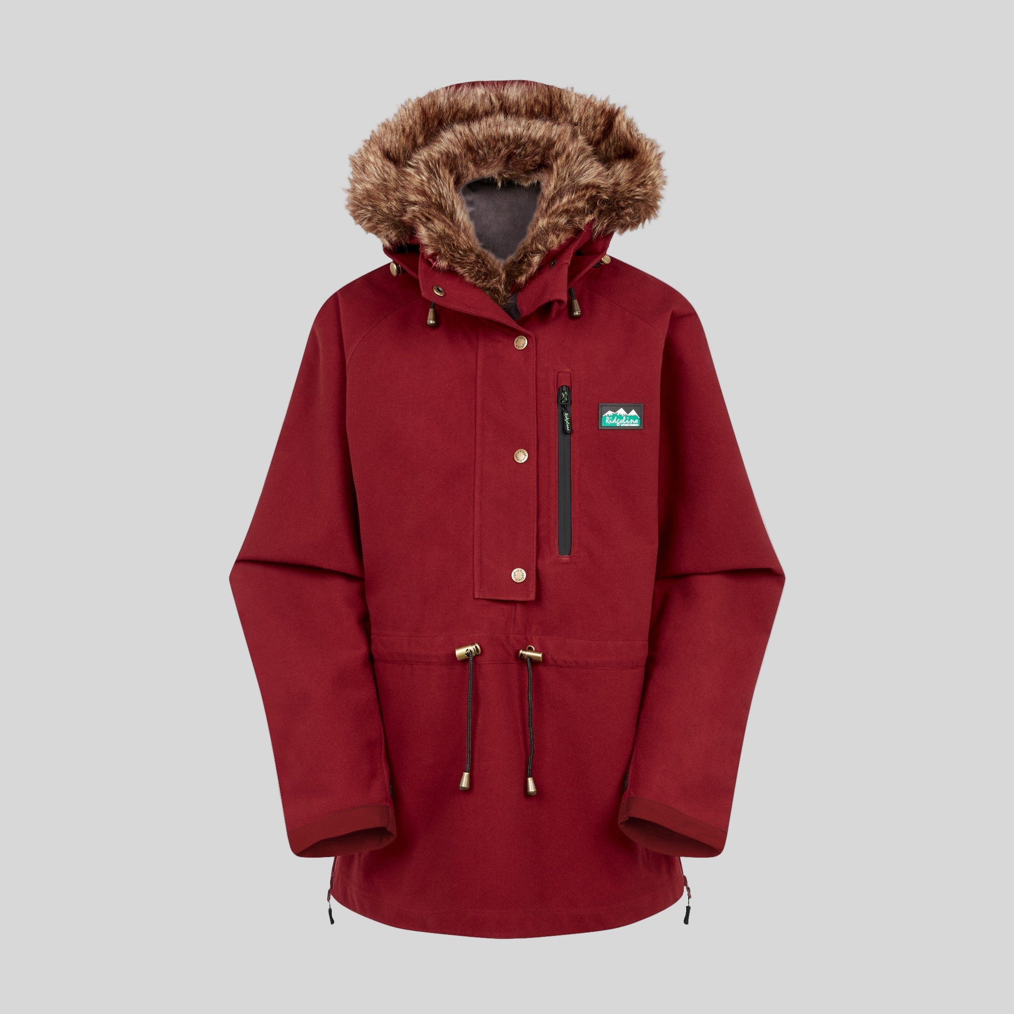 A red Monsoon II Arctic Smock with a faux fur hood, featuring multiple zippers and a scooped back, displayed against a white background.