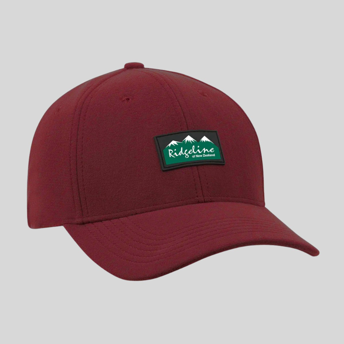 Burgundy or Red curved-brim baseball cap with Ridgeline logo patch on the front, angled front view.