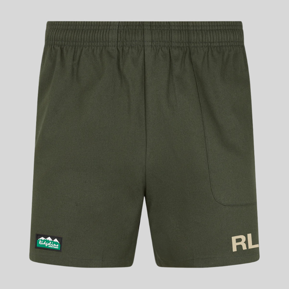 A pair of red rugby shorts with a visible brand logo on the left leg and a small green badge on the right pocket.