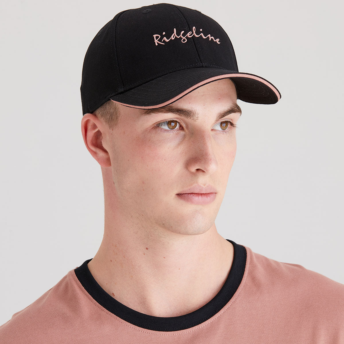 Man wearing a black cap with 'Ridgeline' branding on a light gray background