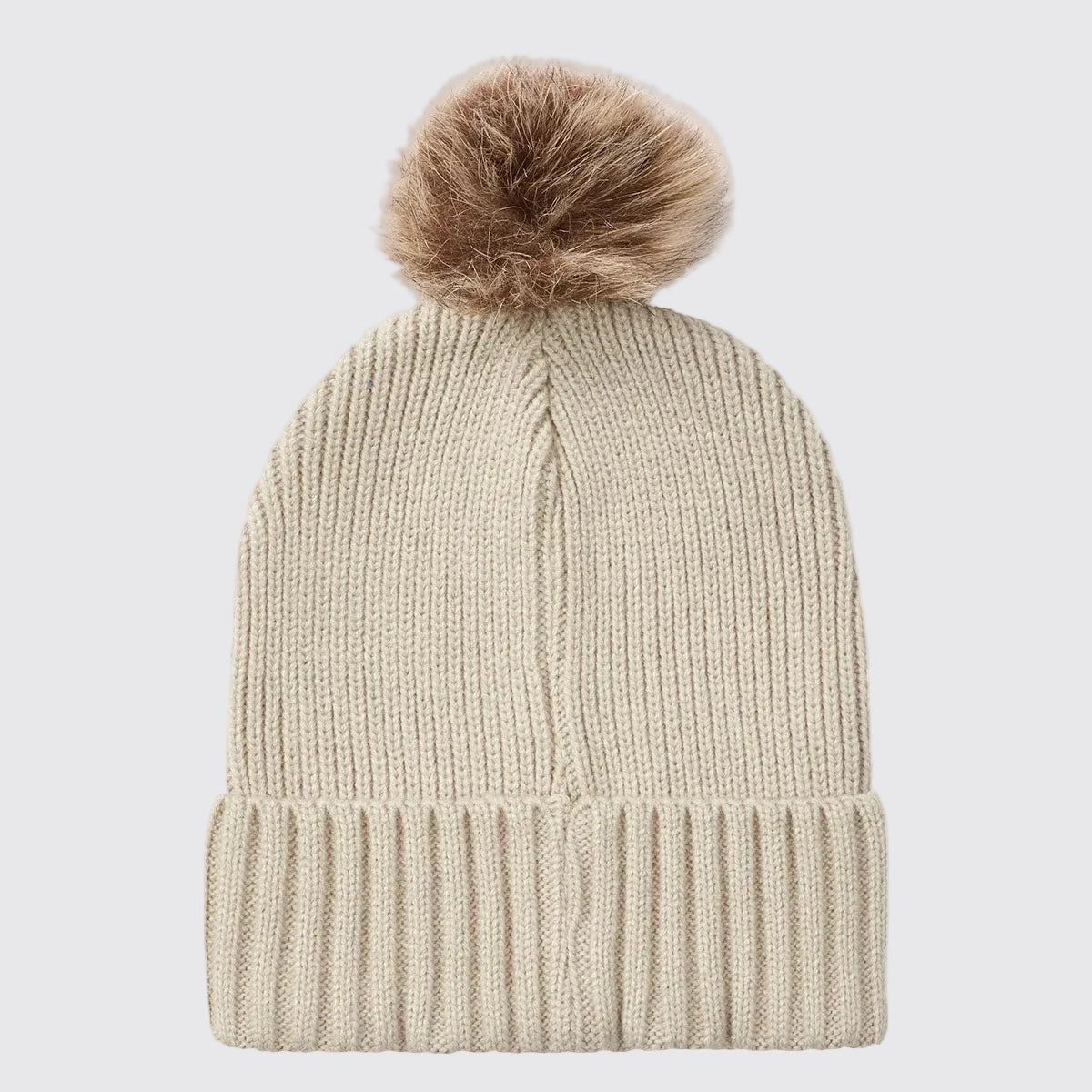 Cream ribbed knit beanie hat with faux fur pom pom, back view.