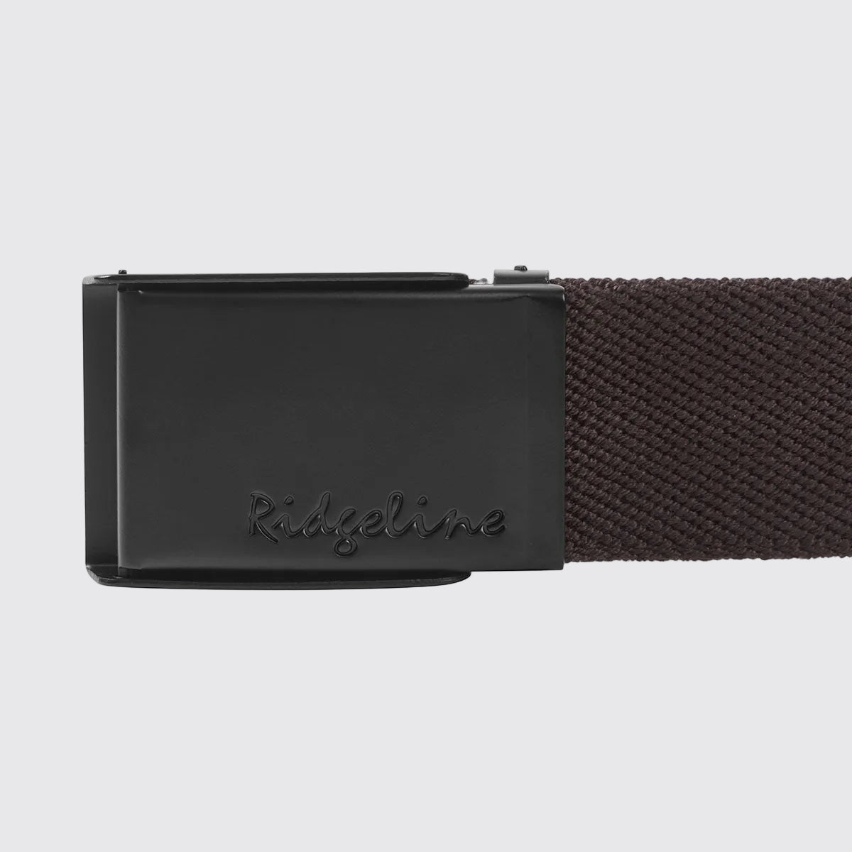 Brown woven fabric belt with Ridgeline‑inscribed black plaque buckle, close-up view
