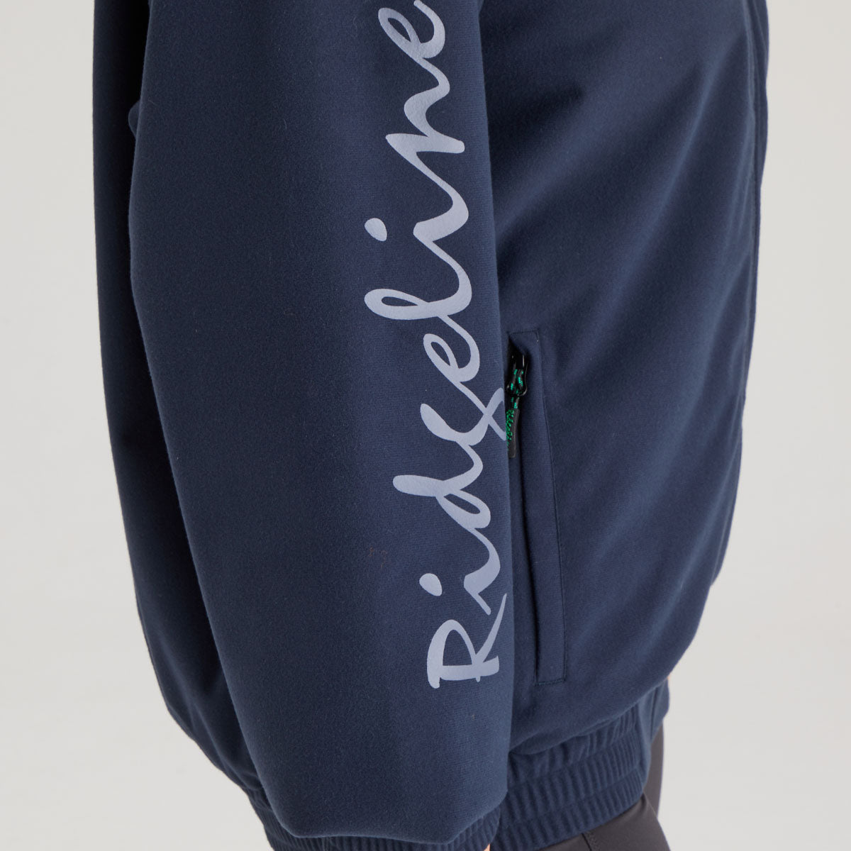 Navy blue jacket with 'Ridgeline' branding on a light gray background
