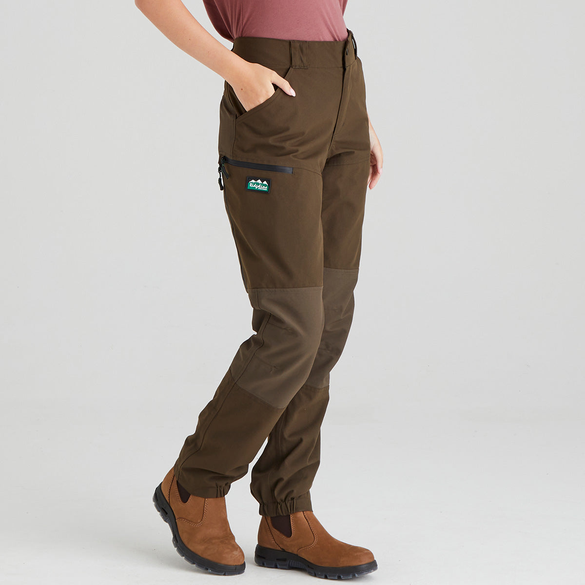 Brown pants worn by a person on a light gray background