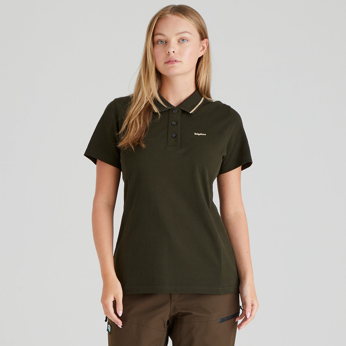Woman wearing a dark green polo shirt with a Ridgeline Clothing brand logo on a grey background