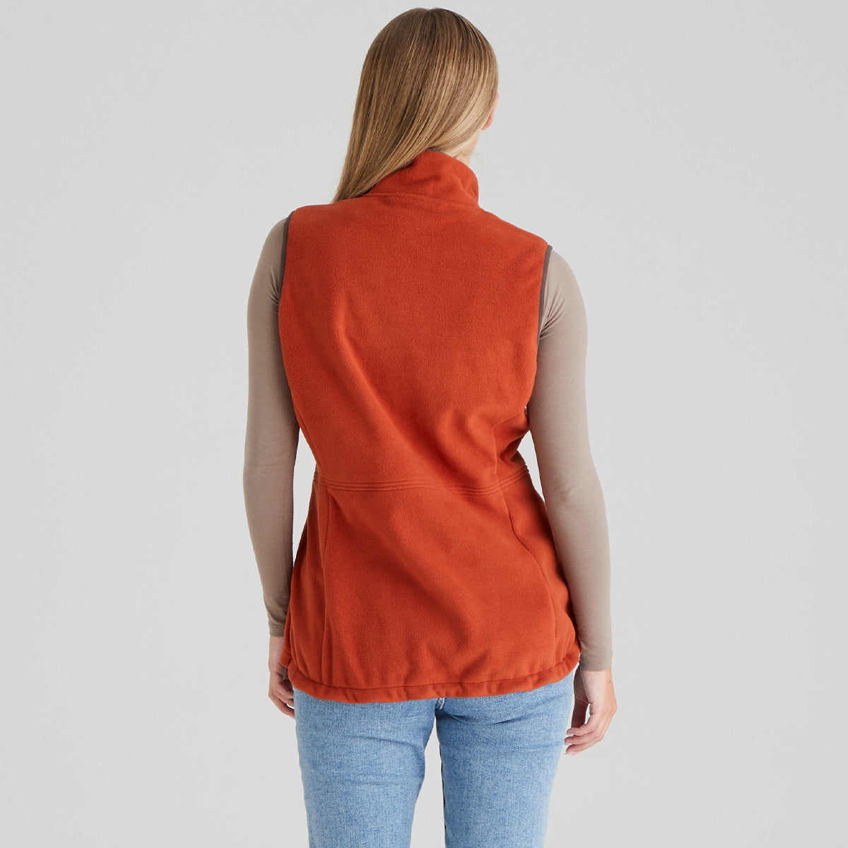 Person wearing a orange vest on a light grey background