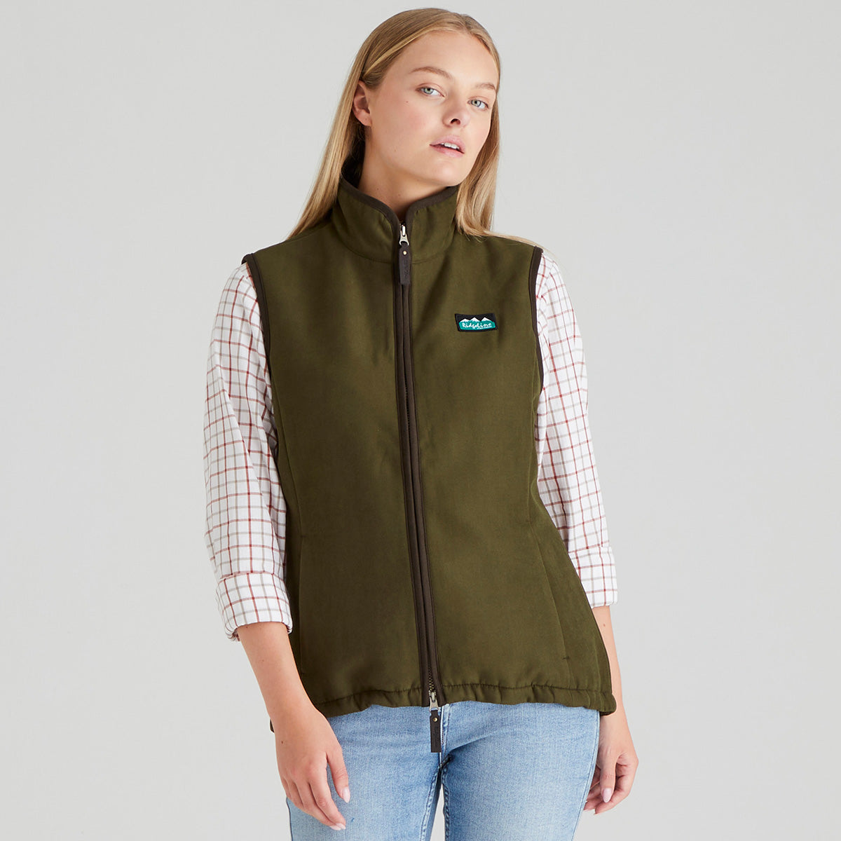 Woman wearing brown moleskin gilet with checked shirt