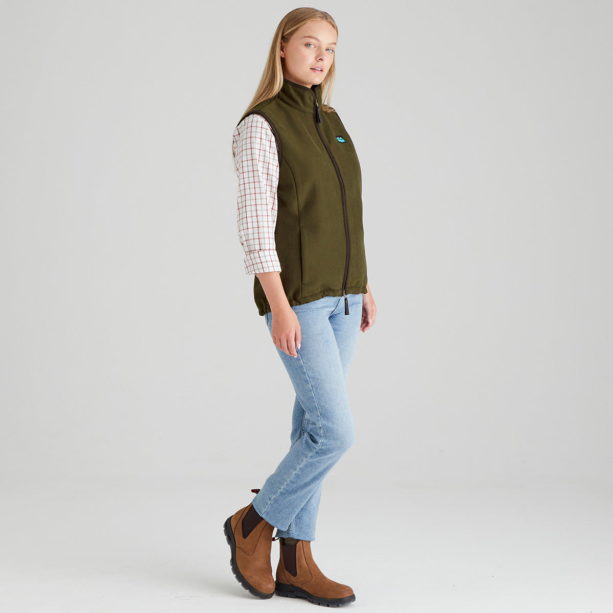 Woman wearing brown moleskin gilet with checked shirt