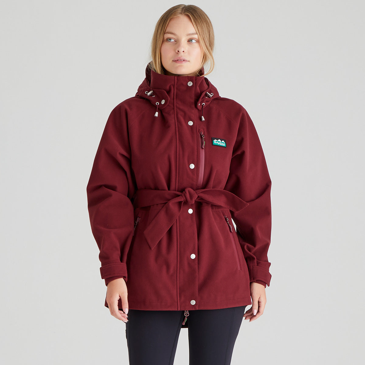 Maroon jacket with a brand logo on a grey background
