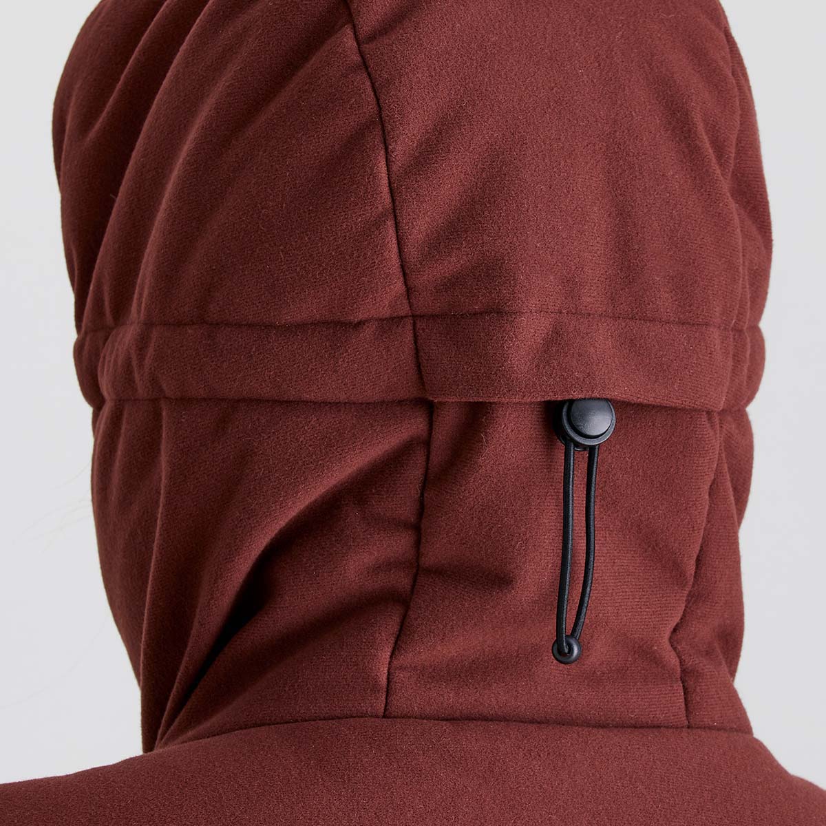 Close-up detail of a Ridgeline burgundy insulated jacket hood showing the rear adjustable drawcord and toggle for a customised fit.
