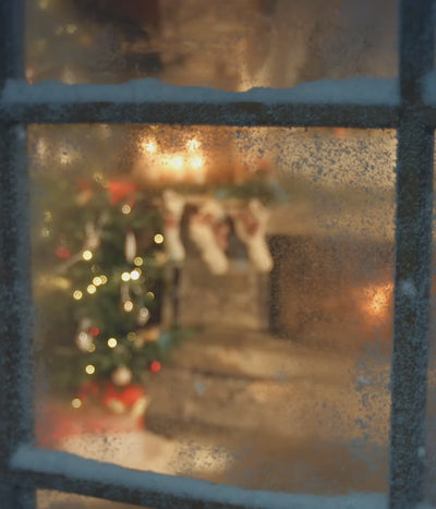 Video zooming in through window showing cosy Christmas setting